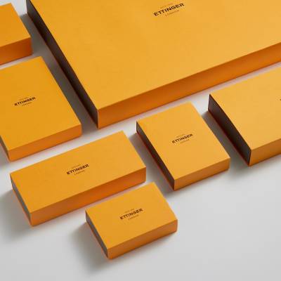 A range of orange Ettinger packaging of different sizes laid out.